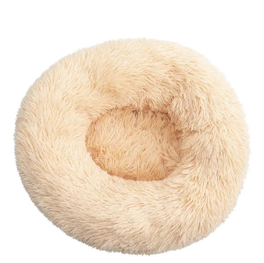 Round beige apricot pet bed on a white background