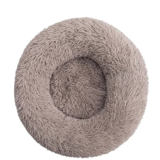 Round, fluffy pet bed in gray on a white background