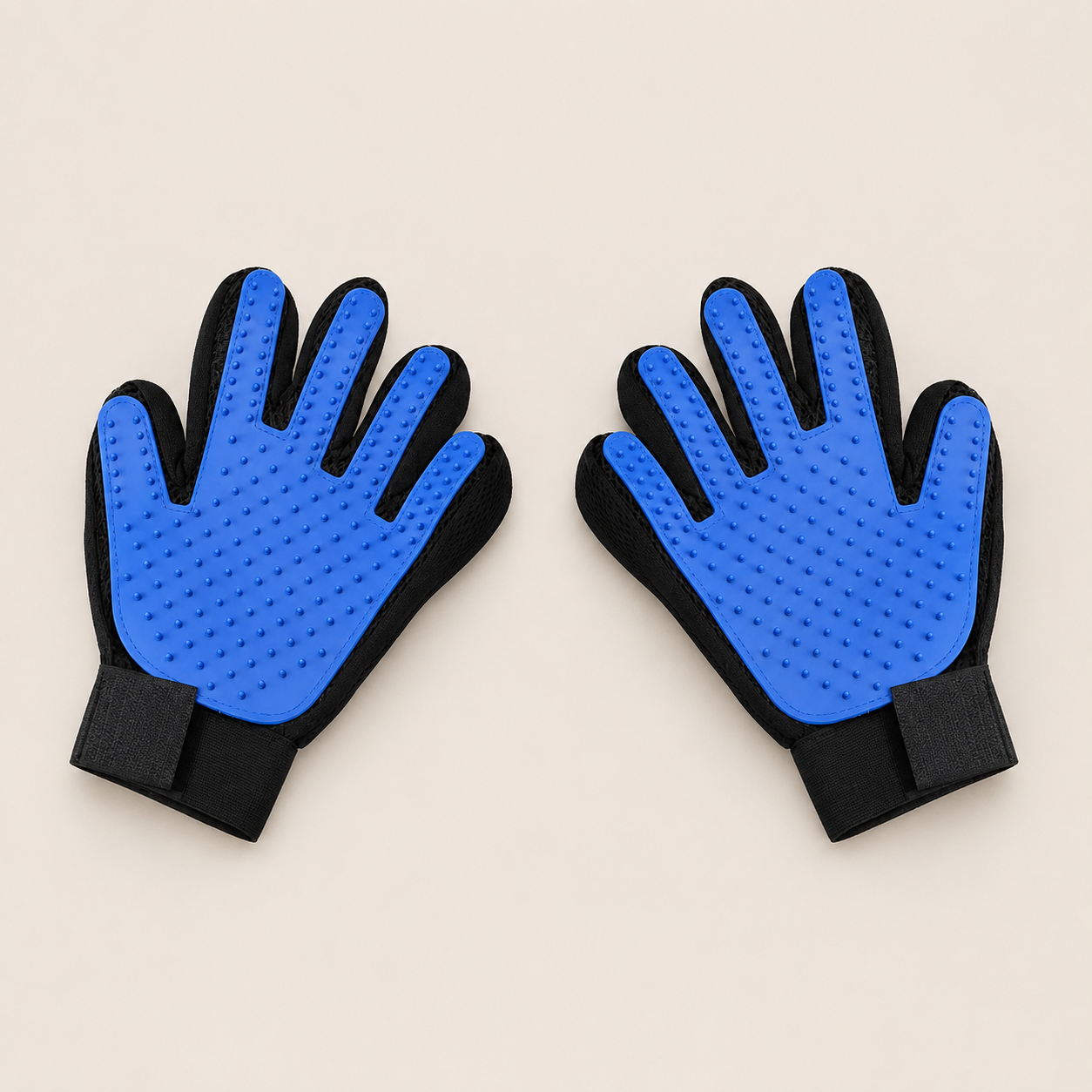 A pair of pet grooming gloves with bright blue textured silicone pads on the palms and black fabric backs and wrist straps, displayed on a light beige background.
