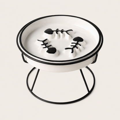 Black and white cat feeding bowl sitting in a black iron stand