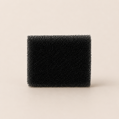 Black rectangular foam filter on a beige background