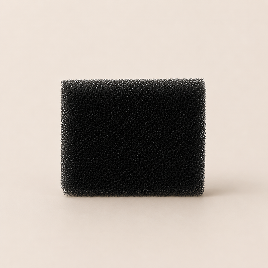 Black rectangular foam filter on a beige background