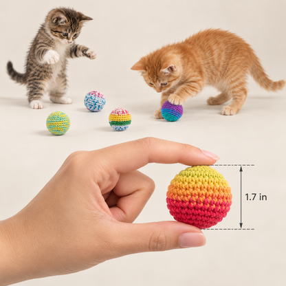 A hand holds a small crocheted ball in the foreground, with two kittens in the background playing with similar colorful balls. A measurement label reads 1.7 in.