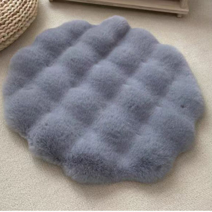 Blue fluffy cushion mat on a beige surface