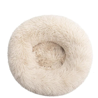Round, plush pet bed with a soft texture on a white background