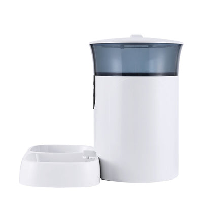 White and grey cylindrical container with a smaller white dish on a white background