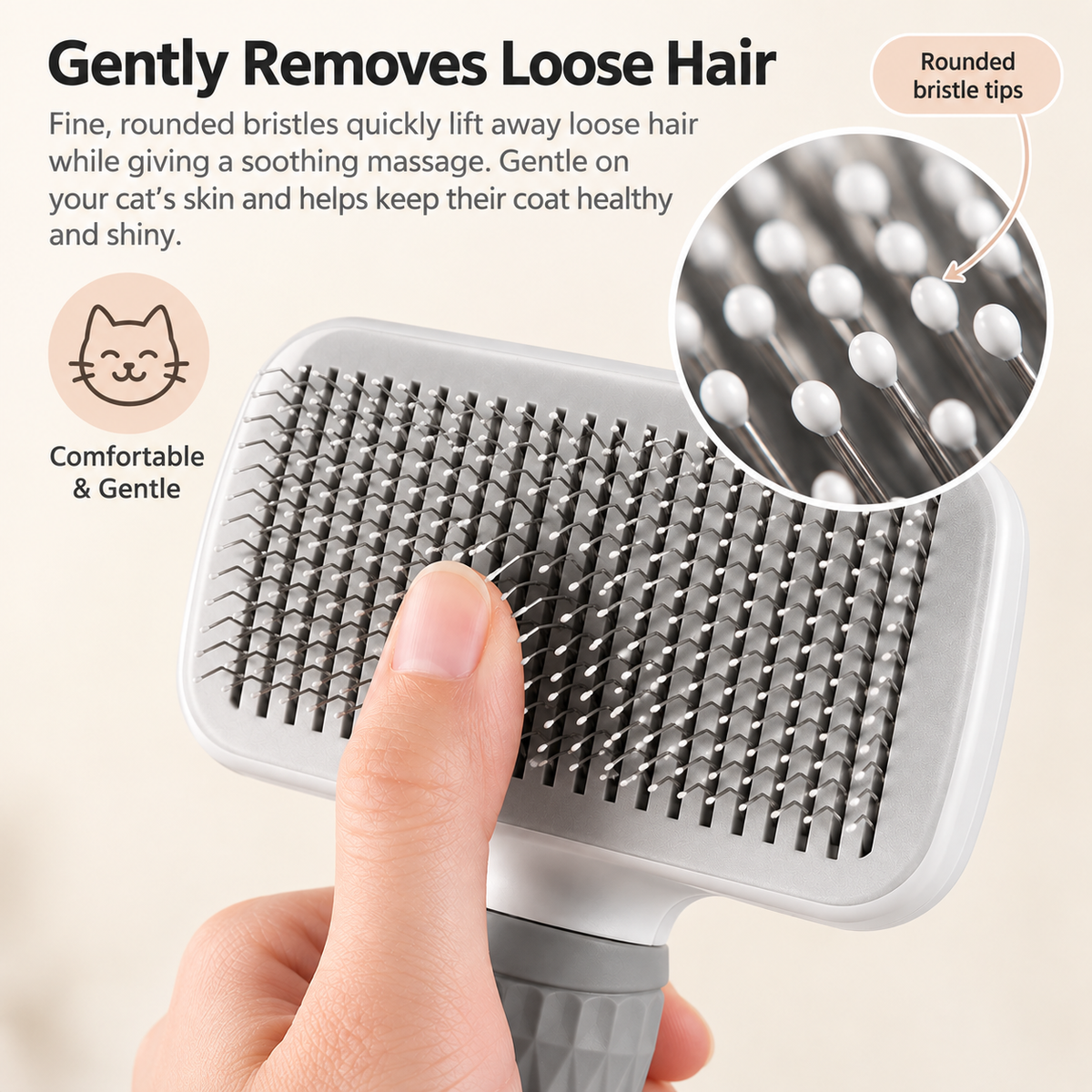 A close-up of a pet grooming brush being held by a human hand, with marketing text and an inset showing the rounded bristle tips. The brush has a white top, silver metal bristles, and a gray handle.