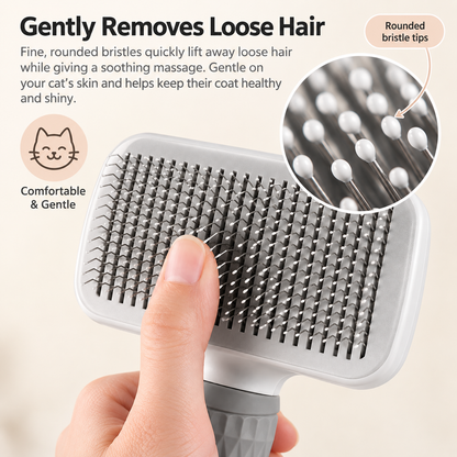A close-up of a pet grooming brush being held by a human hand, with marketing text and an inset showing the rounded bristle tips. The brush has a white top, silver metal bristles, and a gray handle.