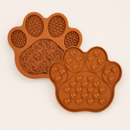 Two brown silicone paw-shaped molds, one showing the textured interior design and the other showing the raised suction cup details, on a light beige background.