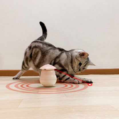 Cat playing with a laser pointer on a wooden floor.