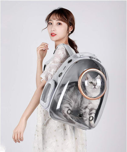 Woman wearing a space capsule cat backpack with a cat inside on a plain background