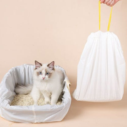 Cat sitting inside a portable litter box with a hand holding a white garbage bag with drawstring on a beige background