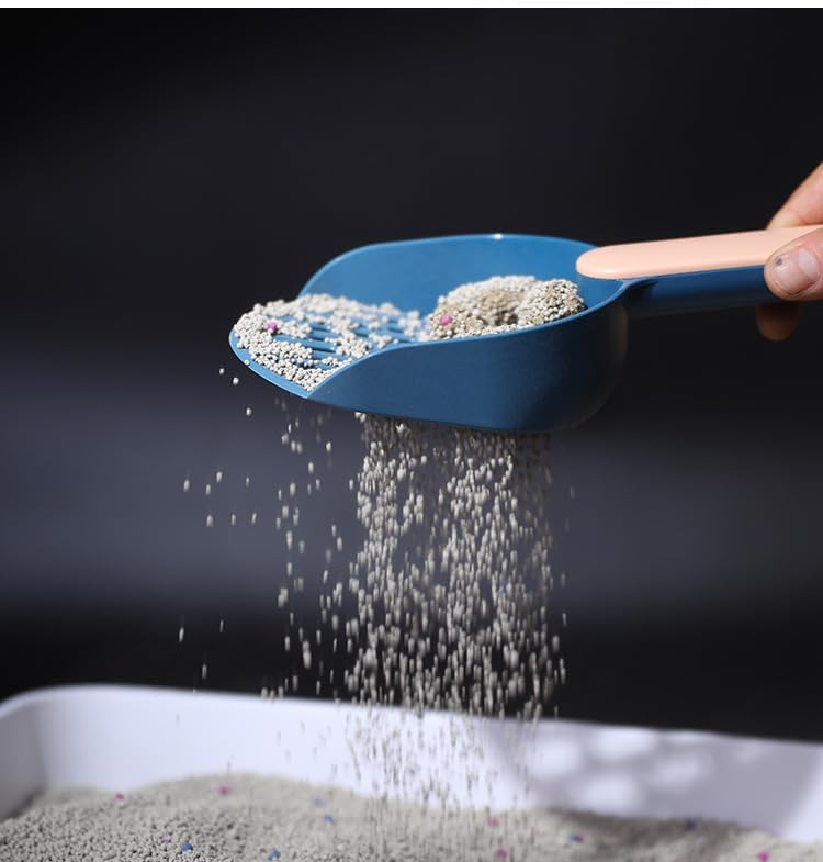 Blue scoop with cat litter being poured onto a surface