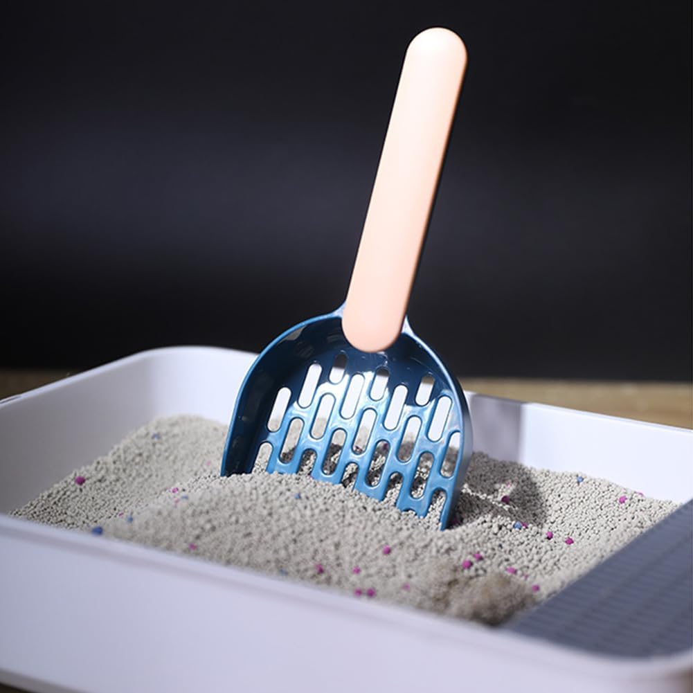 Blue scoop in a cat litter box with a beige handle