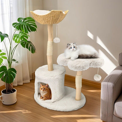 Cat tree with multiple levels and a cat sitting on one of them in a room with a plant and sofa.
