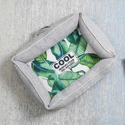 Gray pet bed with a cooling gel base labelled 'Cool' on a textured grey background