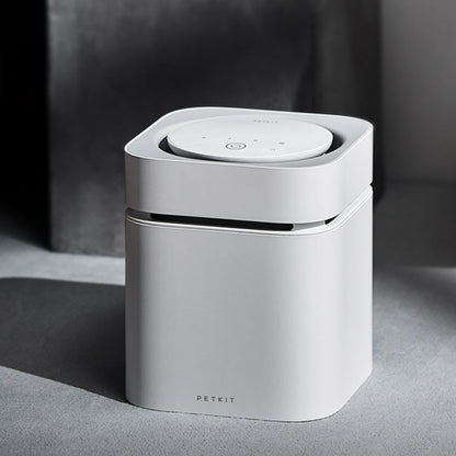 White smart odour eliminator with 'PETKIT' branding on a grey surface.