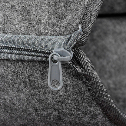 Close-up of a grey zipper, part of the felt tunnel cat cave