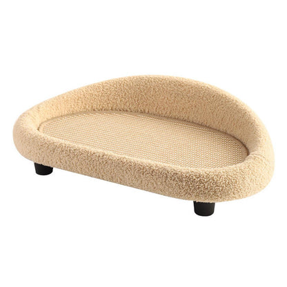Beige cat bed with soft texture and scratching mat on a white background