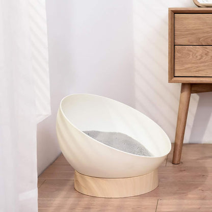 White pet bed with wooden base on a wooden floor next to a wooden cabinet.