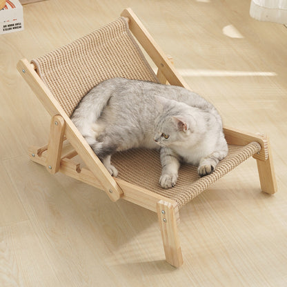 Cat resting on a small wooden deck chair with woven surface on a light wood floor.