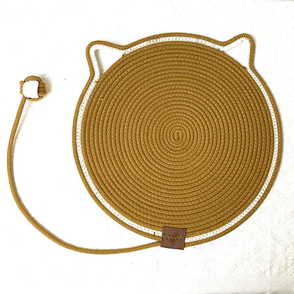 Round woven scratching mat with cat ears and a tail on a white background