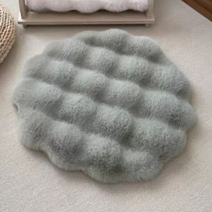Round, textured grey rug on a light-colored floor