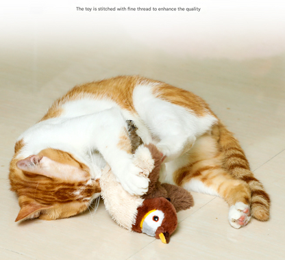 Cat playing with a plush toy resembling a bird on a light-colored floor.