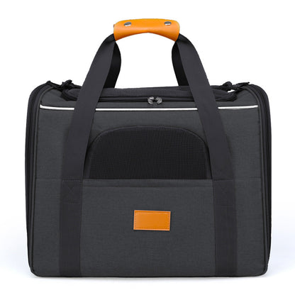 Black pet carrier with orange handle and mesh window on a white background