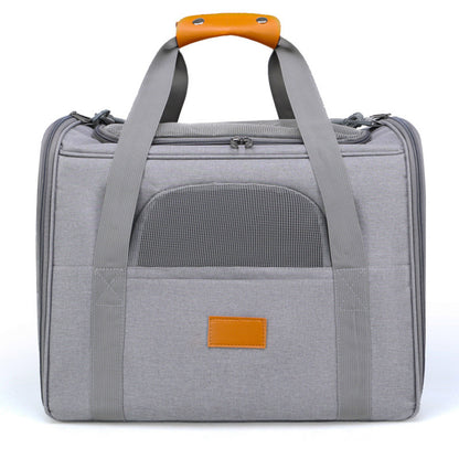 Grey cat carrier with orange handle mesh window on a white background