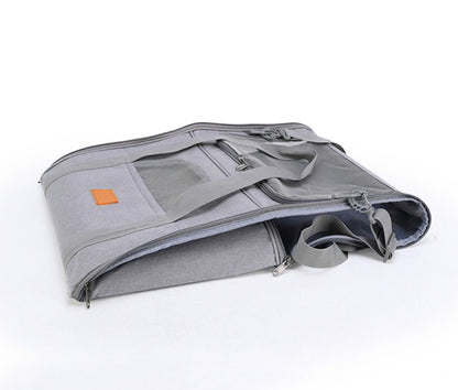 Grey soft cat carrier folded down with a small orange logo on a white background