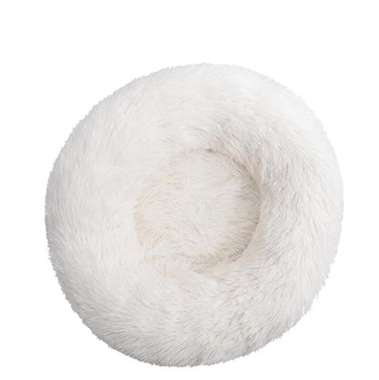 White fluffy donut-shaped pet bed on a white background