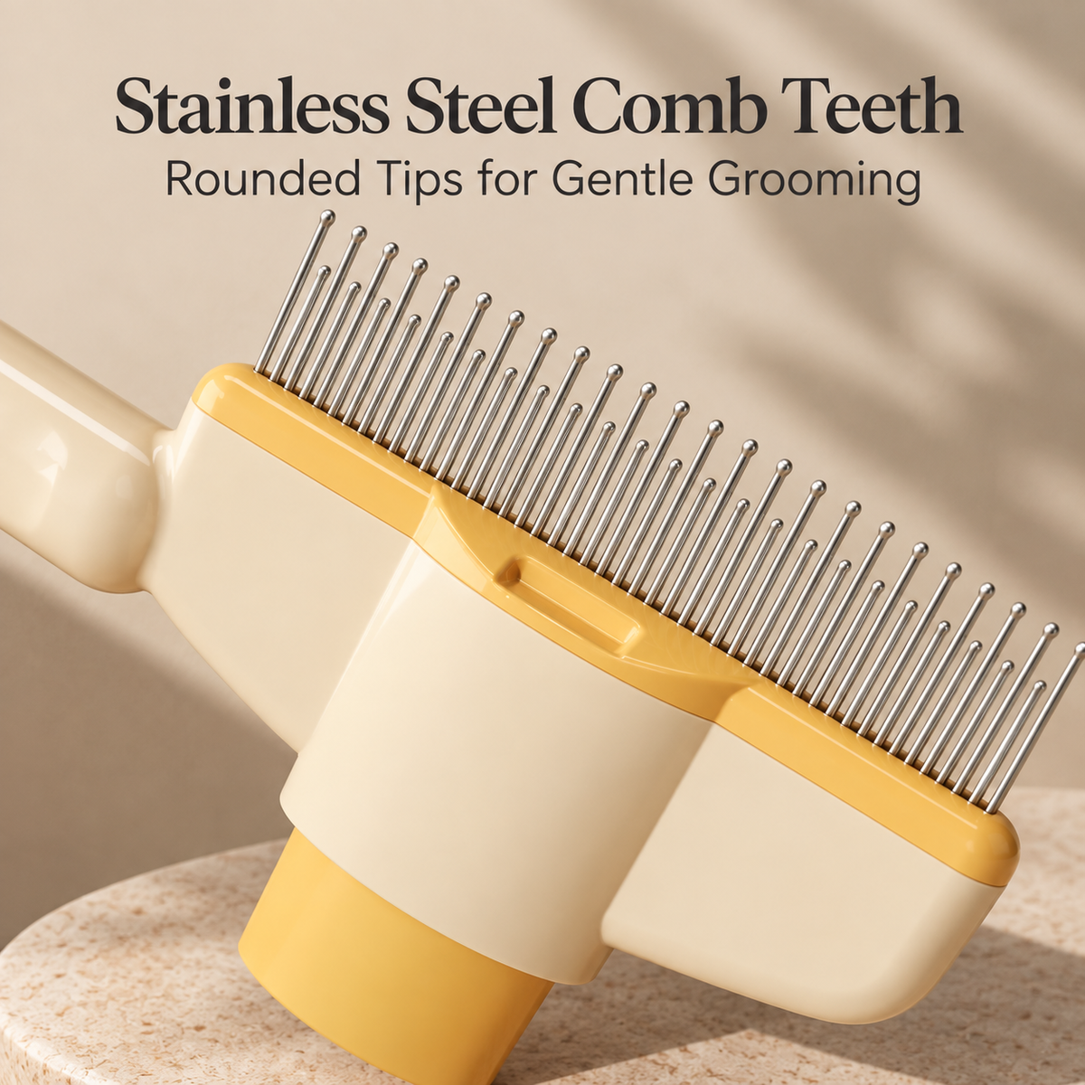 Close-up of a pet grooming comb with rounded stainless steel teeth, cream-colored plastic body, and yellow accents, with text reading 'Stainless Steel Comb Teeth' and 'Rounded Tips for Gentle Grooming' on a warm beige background.